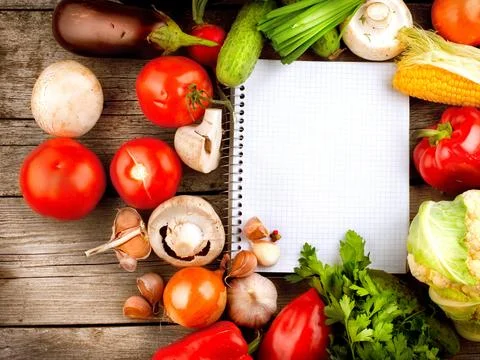 Open Notebook and Fresh Vegetables Background. Diet Stock Photos