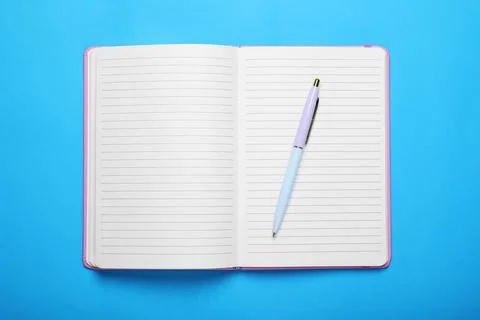 Open notebook and pen on light blue background, top view Stock Photos