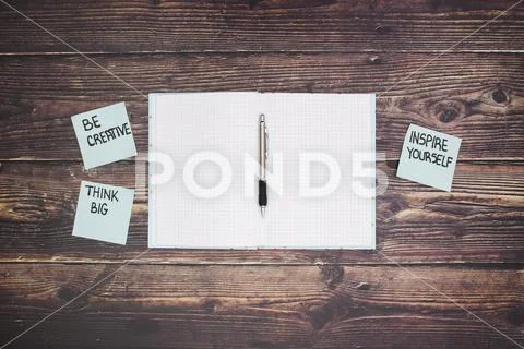 Open notebook and pencil and 3 motivation notes on the paper Stock Photos