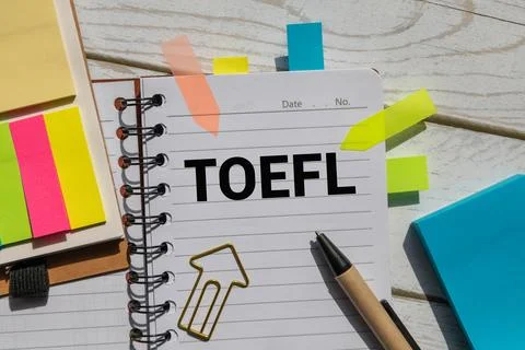 Open notebook and TOEFL text Stock Photos