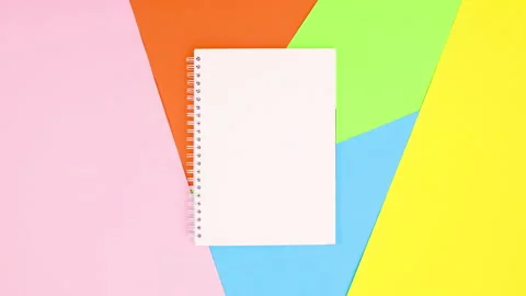 Open notebook appear on colorful theme. Stop motion Stock Footage 147492820
