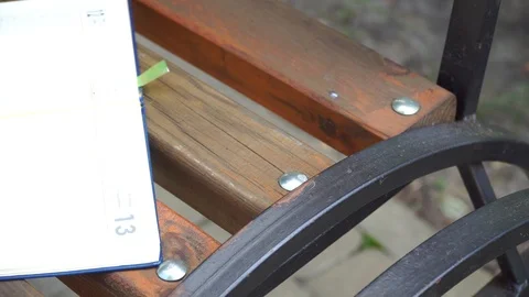 Open Notebook on bench in park, business concept Video stock 93342299