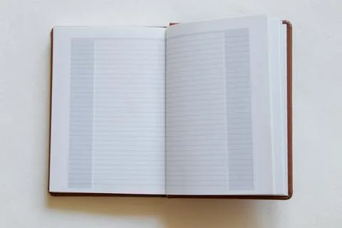 Open notebook with blank page on white background, top view, template for tex Foto stock