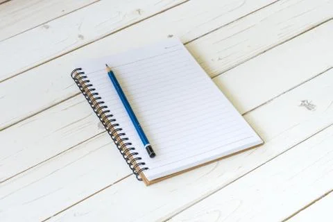 Open notebook with blank pages and pencil on wood table Stock Photos