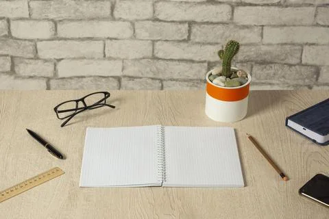 Open notebook with blank sheets, a pen, a diary and more on the desk 스톡 사진