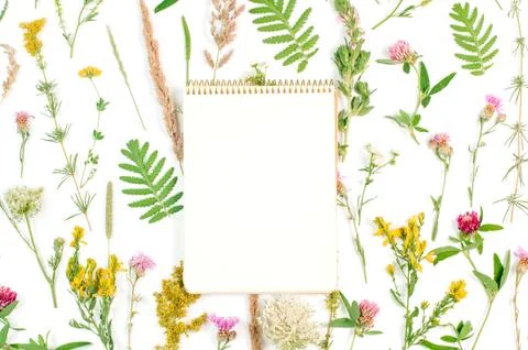 Open notebook with blank space for text on wildflowers background Stock Photos