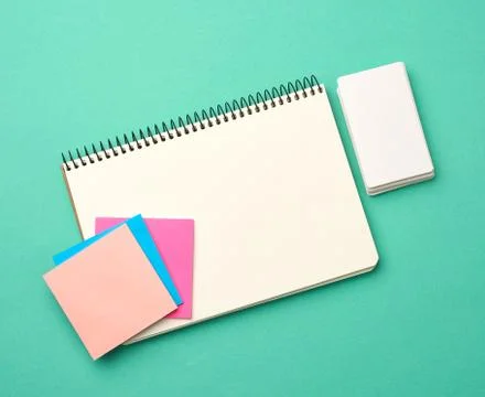 Open notebook with blank white sheets, color stickers and rectangular busines 스톡 사진