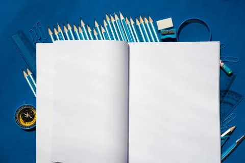 Open notebook on blue background Stock Photos