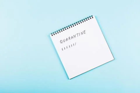 Open notebook on blue paper background, flat lay, top view. Counting days of  Stock Photos