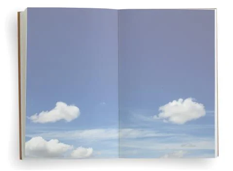 Open notebook with blue sky and cloud background. Stock Photos