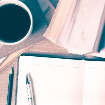 Open notebook with book and coffee cup vintage style Stock Photos