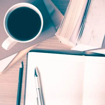 Open notebook with book and coffee cup vintage style Stock Photos