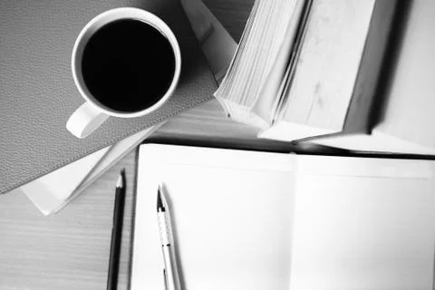 Open notebook with book and coffee cup  black and white color tone style Stock Photos