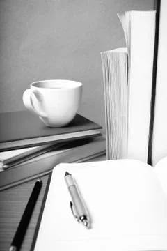 Open notebook with book and coffee cup  black and white color tone style Stock Photos