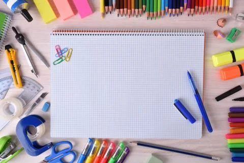 Open notebook in center with school material Stock Photos