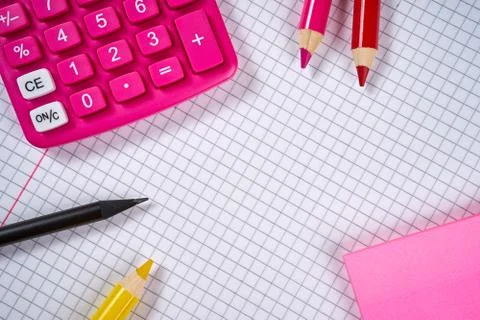Open notebook with checkered pages and calculator and pencil Foto stock