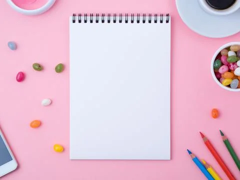 Open notebook with a clean white sheet, caramel, lollipops, Stock Photos
