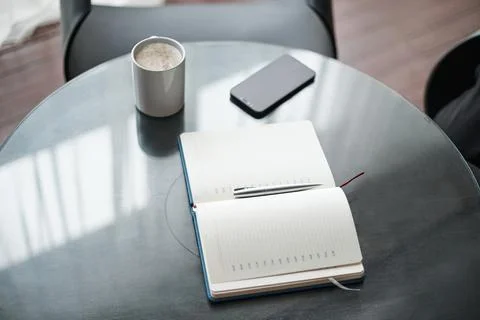 Open notebook on the coffee table. close-up. Stock Photos