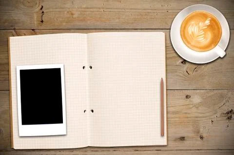 Open notebook with cup of coffee and photo Stock Photos