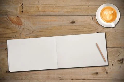 Open notebook with cup of coffee Stock Photos