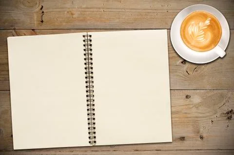 Open notebook with cup of coffee Stock Photos