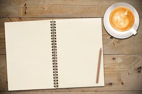 Open notebook with cup of coffee Stock Photos