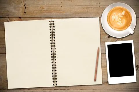 Open notebook with cup of coffee Stock Photos