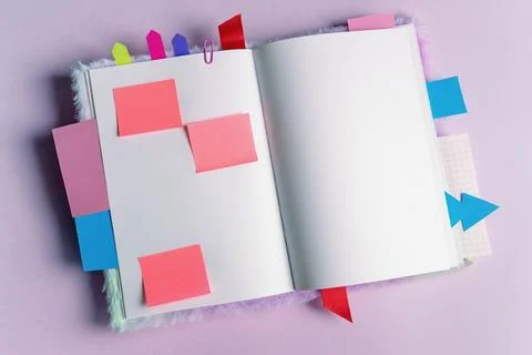 Open notebook with different colorful bookmarks and notes. Copy space Stock Photos