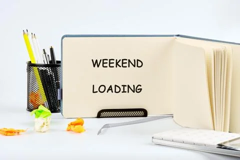 An open notebook displays the phrase WEEKEND LOADING. Nearby are writing 스톡 사진
