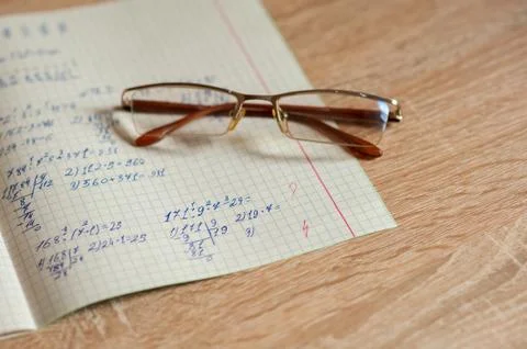 An open notebook with examples are on the table Stock Photos