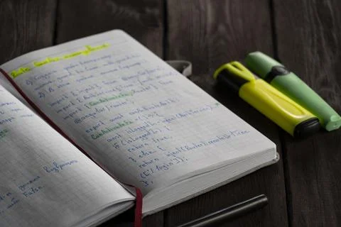Open notebook filled with handwritten Angular code and notes Stock Photos