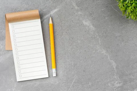 Open notebook on gray marble background. Stock Photos