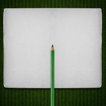 Open notebook with green crayon Stock Photos