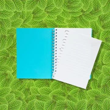 Open notebook on green leafs background Stock Illustration