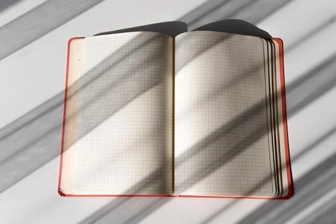 Open Notebook with Grid Pages and Soft Shadows from Natural Light Stock Photos