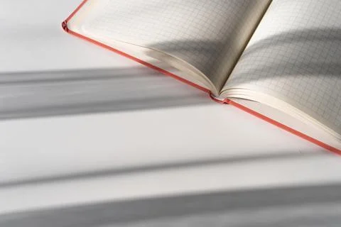 Open Notebook with Grid Pages and Soft Shadows from Natural Light Stock Photos
