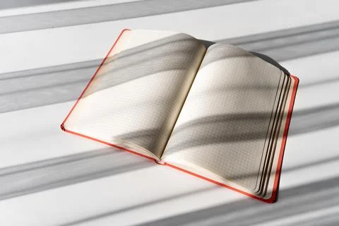Open Notebook with Grid Pages and Soft Shadows from Natural Light Stock Photos