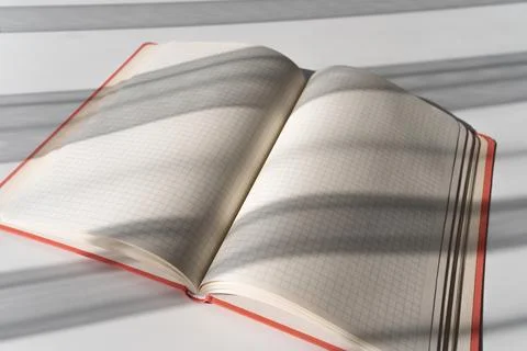 Open Notebook with Grid Pages and Soft Shadows from Natural Light Stock Photos