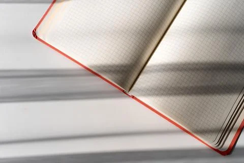 Open Notebook with Grid Pages and Soft Shadows from Natural Light Stock Photos