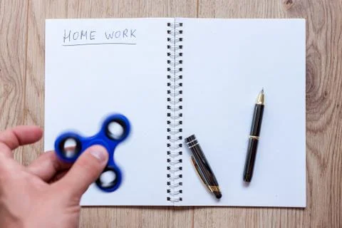 Open notebook for home work distracting spinner Stock Photos