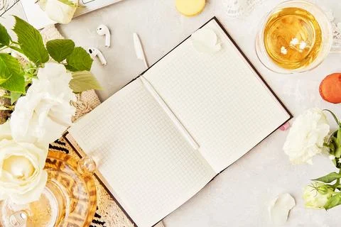 Open notebook mock up, herbal tea and earphones. Audiohealing concept. Aesthetic Stock Photos