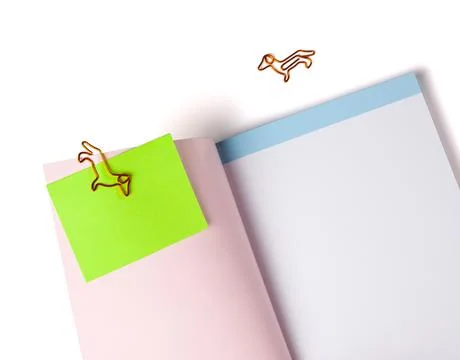 An open notebook or book with blank pages with note paper attached with a dog Stock Photos