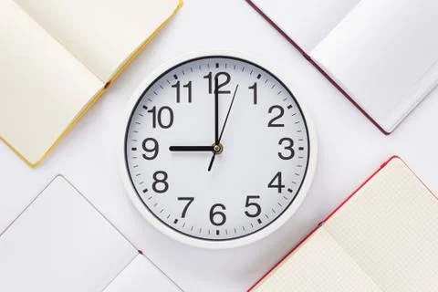 Open notebook or book with wall clock Stock Photos
