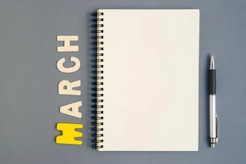 Open notebook with pen and March text Stock Photos
