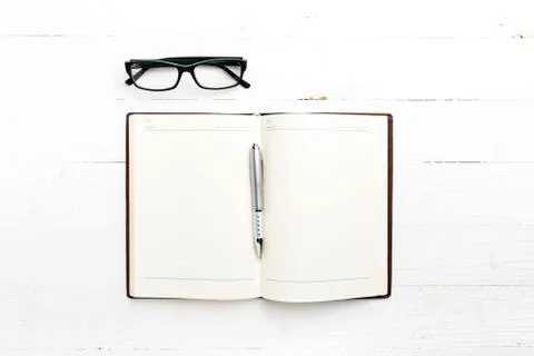 Open notebook with pen Stock Photos