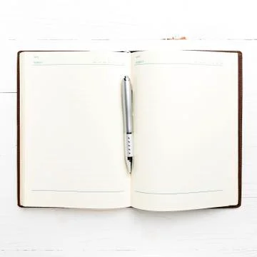 Open notebook with pen Stock Photos