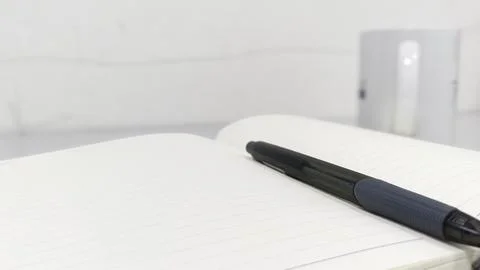 An Open Notebook with a Pen Resting on Its Lined Pages, Exuding a Professio.. Stock Photos