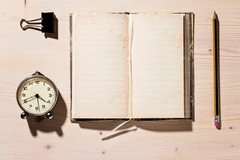 Open Notebook, Pencil and Clock Stock Photos