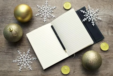 Open notebook with pen.writing notes and goals. New year's gold background Stock Photos