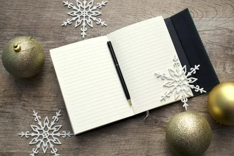 Open notebook with pen.writing notes and goals. New year's gold background Stock Photos